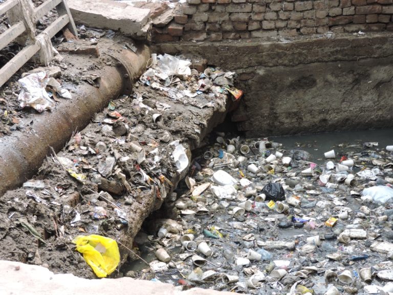 Near Harinikunj, Vidya Peeth. This is on the main road just before turning off for Bankey Bihari. All visitors will pass by this open cesspool. Actually, they have been trying to do some cleaning here, and there is a big pile of detritus on the street next to this open drain.